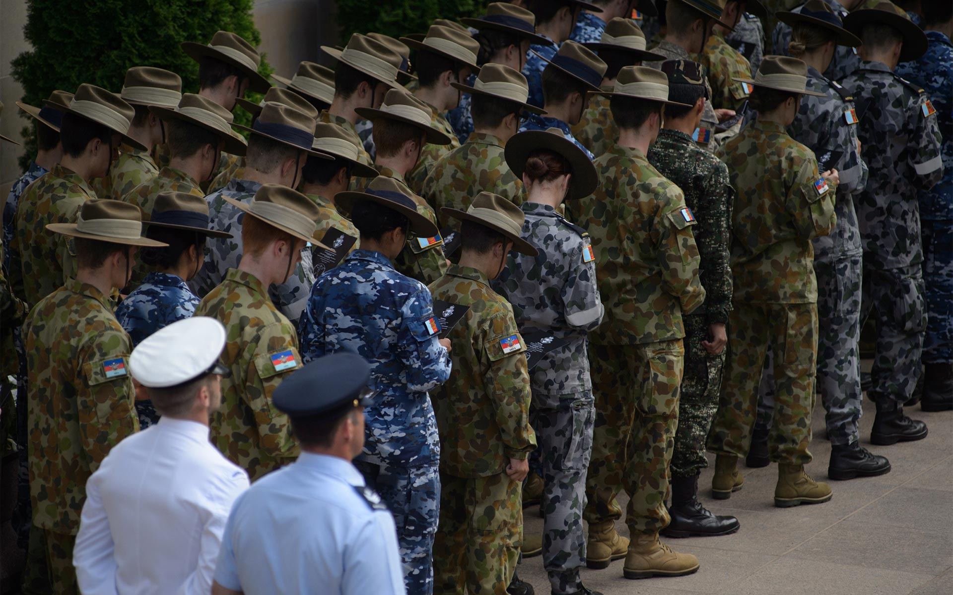 ADF personnel with heads bowed