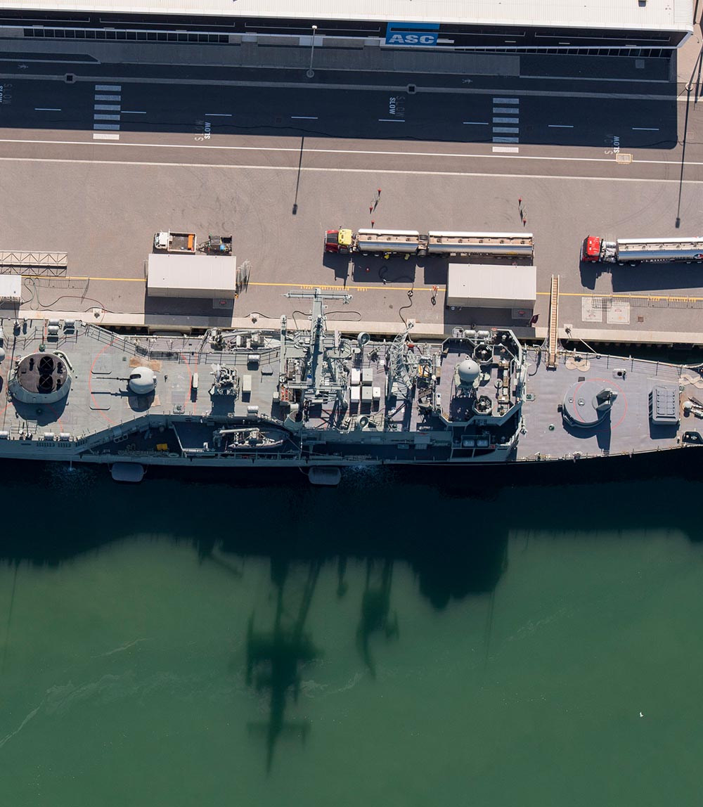 Aerial shot of a navy ship docked at ASC